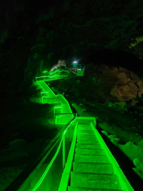 Kow-Ata underground lake in Turkmenistan with a green-lit walkway inside the cave