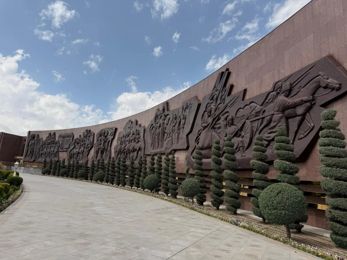Large-scale bas-relief featuring historical scenes and horsemen at the Halk Hakydasy Memorial Complex, Ashgabat, Turkmenistan