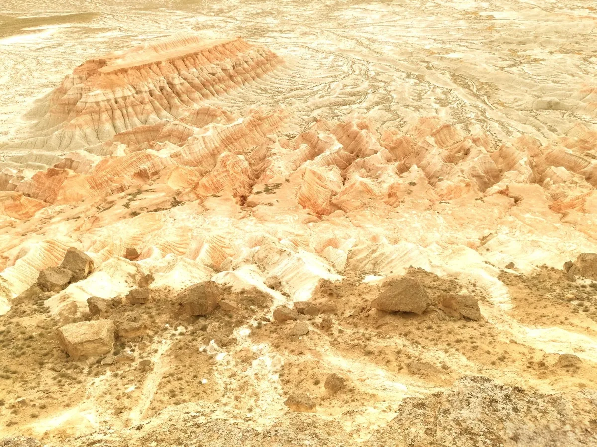 Yangykala Canyons in Turkmenistan with red-and-white layered ridges and a vast desert panorama